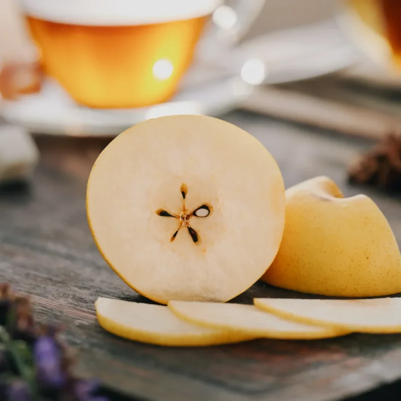 Artisanal Asian pear on cutting board with tea