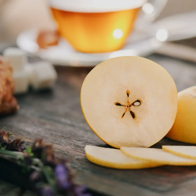 RuthiSan Pear on cutting board with tea & lavender.