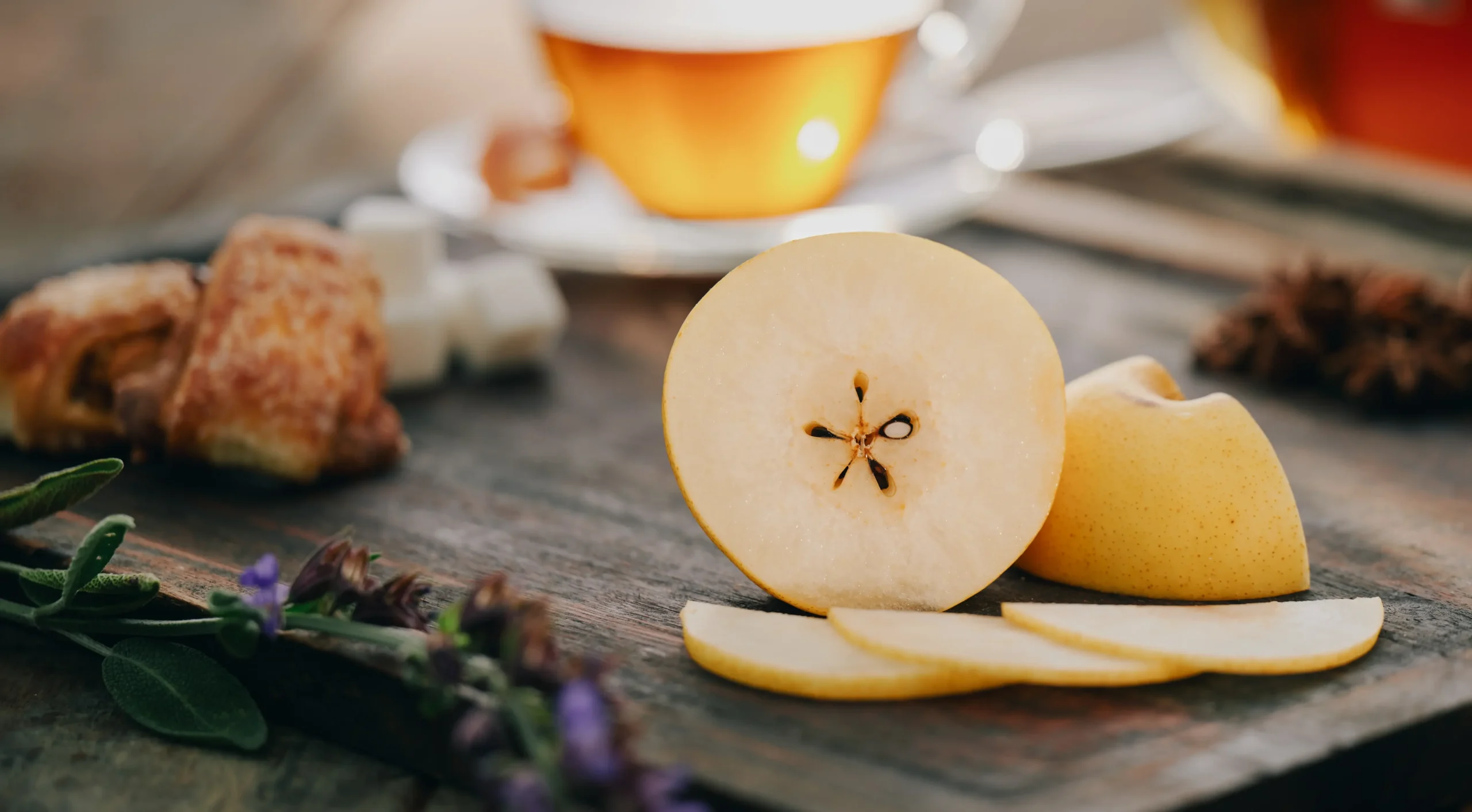 RuthiSan Pear on cutting board with tea & lavender.